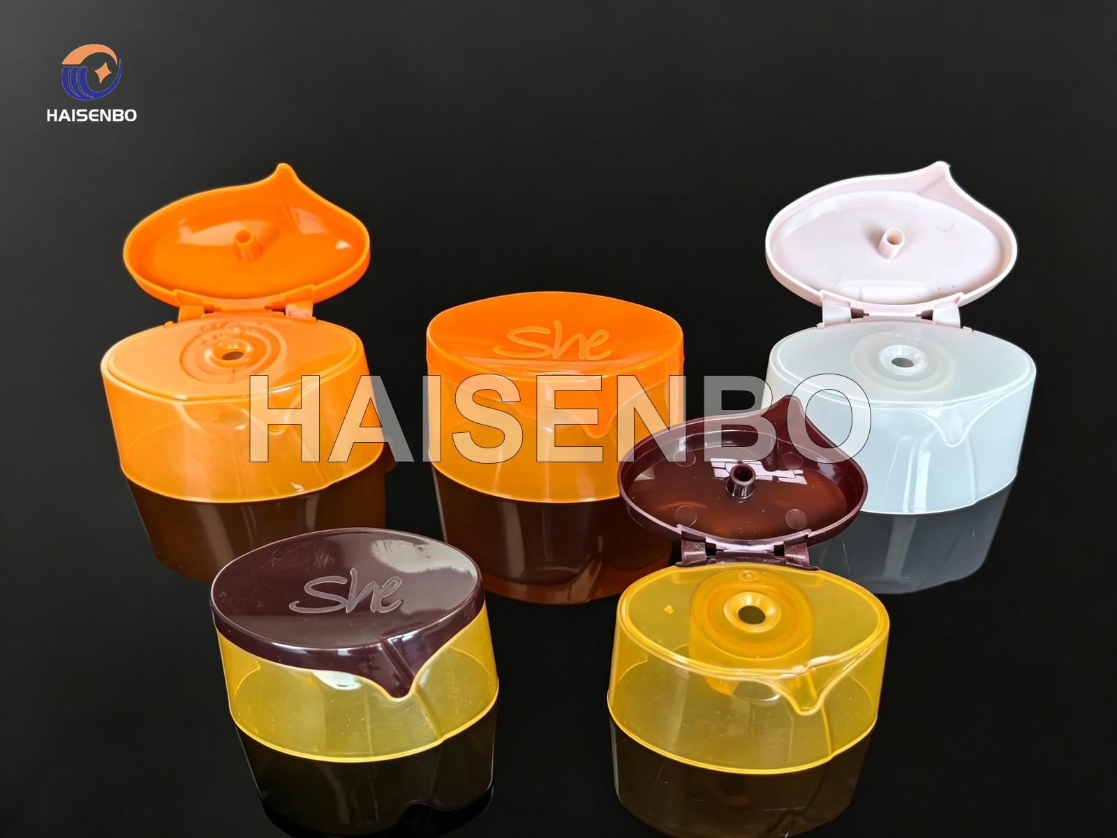 Group of multi-color two-color flip top caps assembled from separate single-color parts