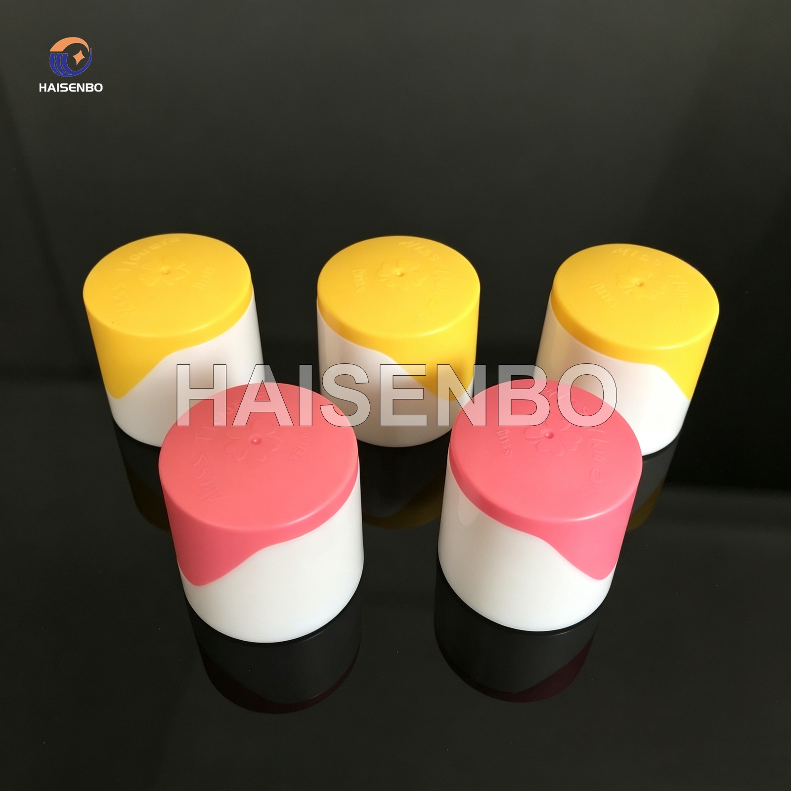 Cylindrical two-color caps assembled from two tone parts